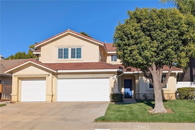 view of front facade with fence, a tile roof, a front yard, stucco siding, and driveway