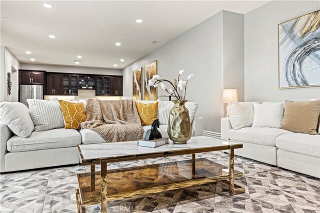 living room with recessed lighting and marble finish floor