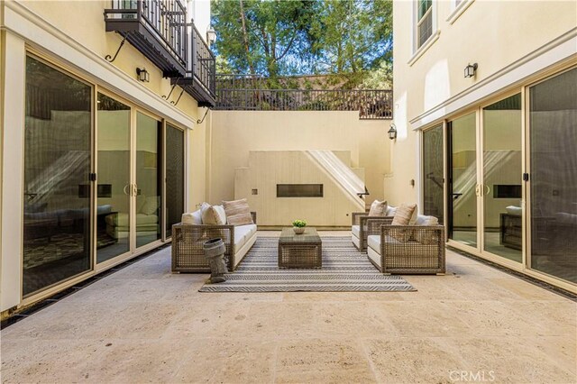 view of patio / terrace with a balcony and an outdoor hangout area