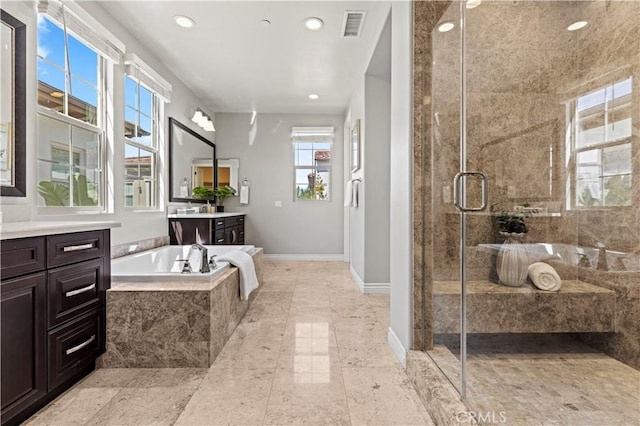 full bathroom with visible vents, a garden tub, a stall shower, baseboards, and vanity