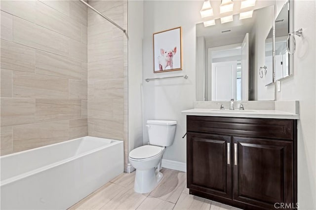 full bath with baseboards, toilet, vanity, and  shower combination