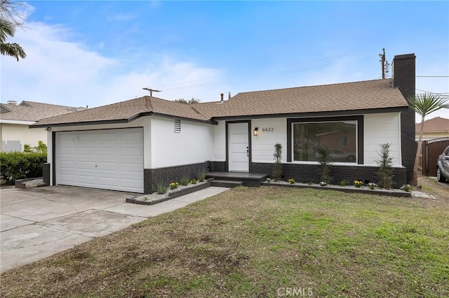 ranch-style house featuring brick siding, a front lawn, a chimney, driveway, and an attached garage