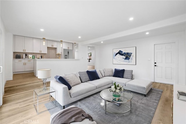 living area featuring recessed lighting and light wood-type flooring