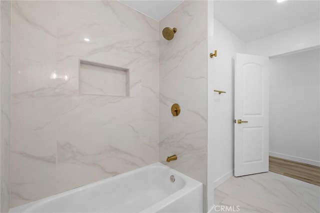 full bathroom with marble finish floor, shower / bathing tub combination, and baseboards