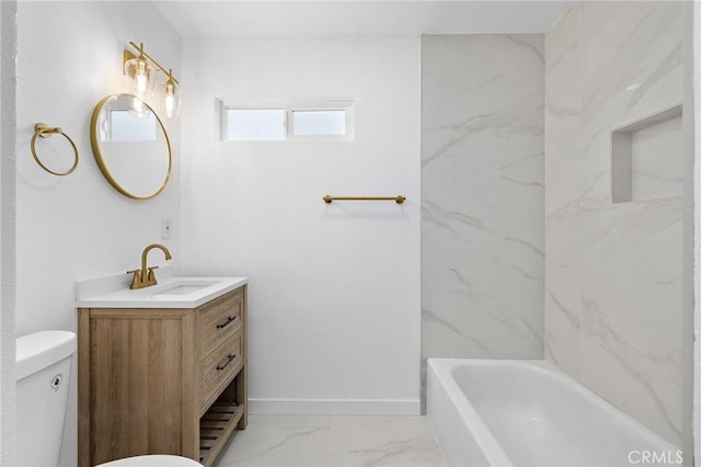 bathroom with baseboards, toilet, a bath, marble finish floor, and vanity