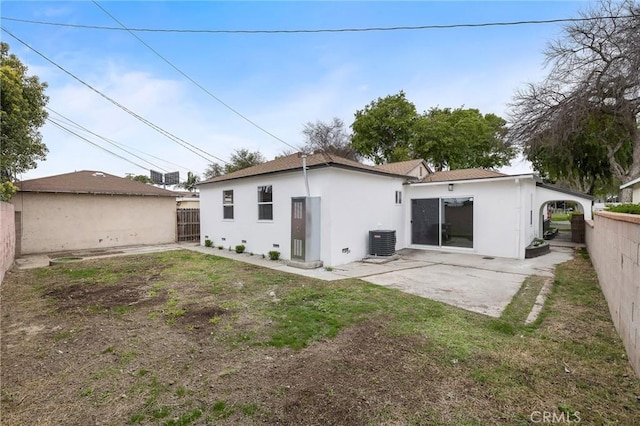 rear view of property with central AC unit, a patio, a fenced backyard, and stucco siding