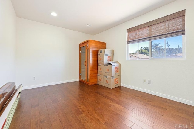 unfurnished bedroom with recessed lighting, baseboards, and hardwood / wood-style flooring