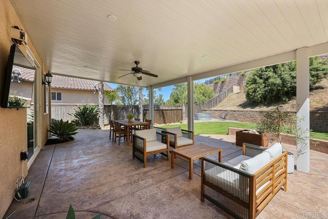 view of patio featuring ceiling fan, outdoor dining area, a fenced backyard, and an outdoor hangout area