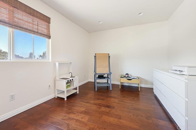 misc room with baseboards and wood finished floors