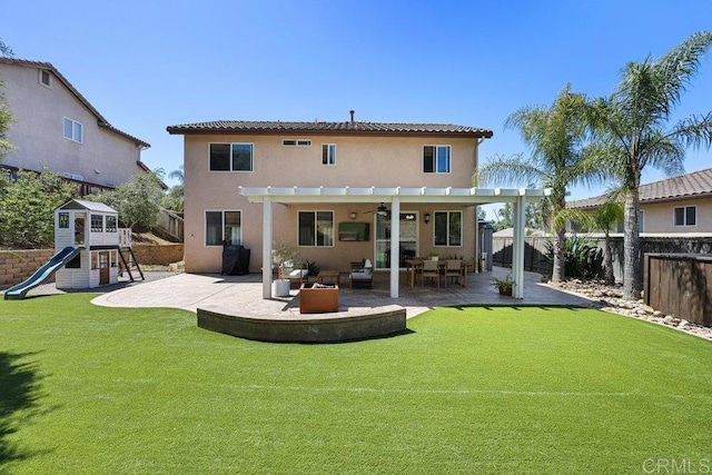 back of house featuring a yard, a fenced backyard, a pergola, a playground, and a patio area