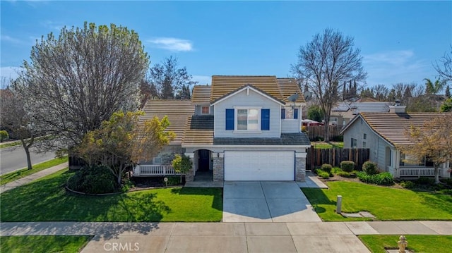 traditional-style home featuring driveway, a front lawn, stone siding, fence, and a tiled roof