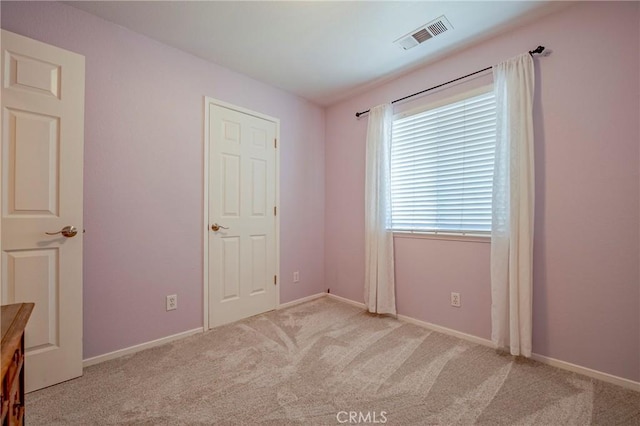 unfurnished bedroom featuring visible vents, baseboards, and carpet