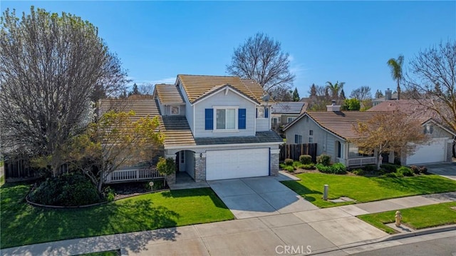 traditional home featuring driveway, an attached garage, a front lawn, stone siding, and a tiled roof