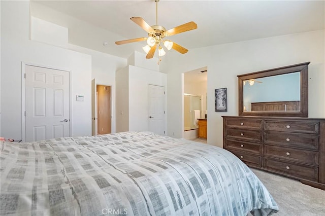 carpeted bedroom with lofted ceiling, ensuite bath, and ceiling fan