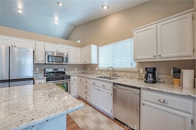 kitchen with white cabinets, stainless steel appliances, and a sink