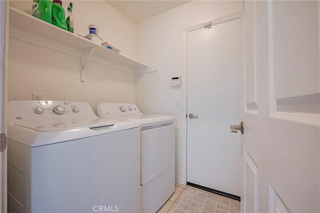 clothes washing area featuring independent washer and dryer and laundry area