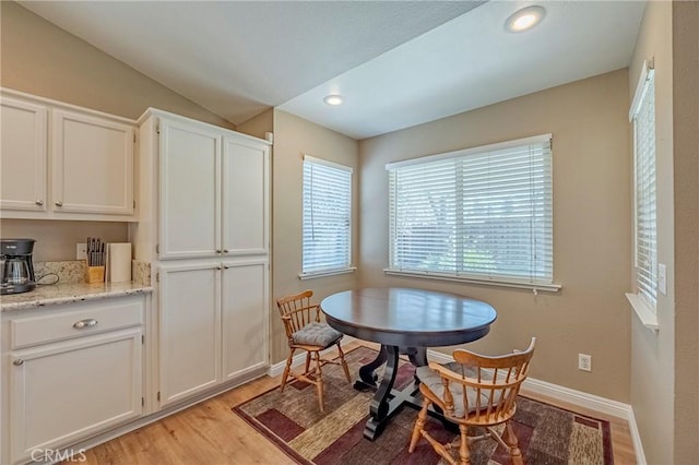 dining room featuring recessed lighting, baseboards, vaulted ceiling, and light wood finished floors