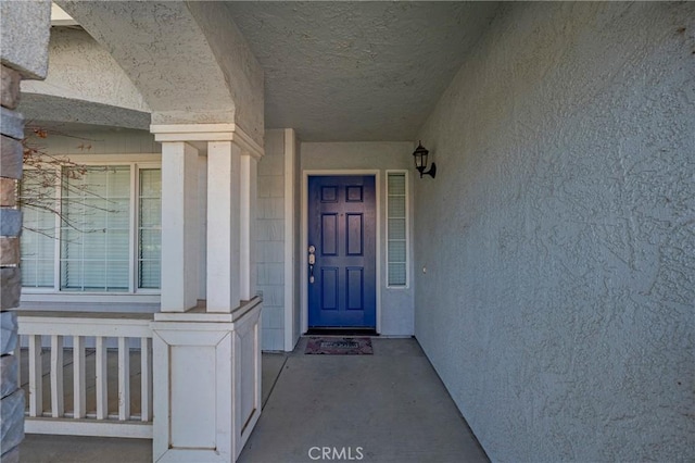 doorway to property with stucco siding