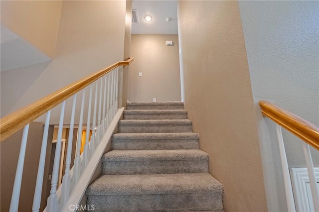 stairway with a textured wall