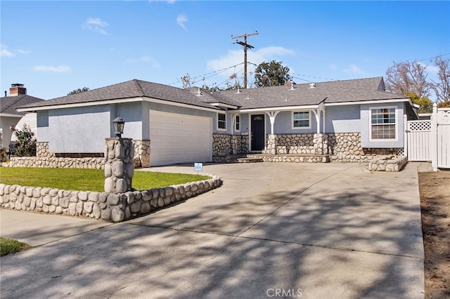 15275 Cedarsprings Dr, Whittier, CA 90603 - view of front of house with stucco siding, stone siding, fence, concrete driveway, and an attached garage