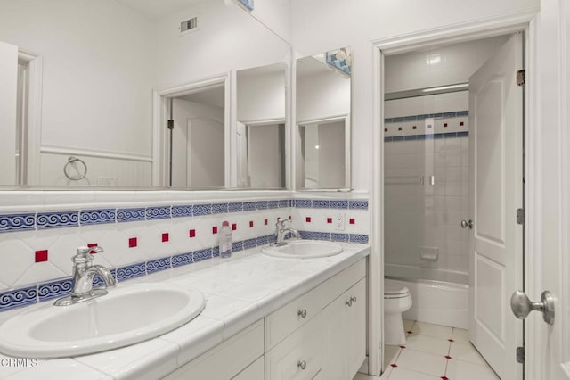 bathroom featuring toilet, tile patterned flooring, visible vents, and a sink