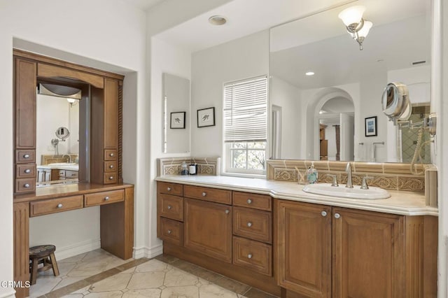 bathroom with vanity, recessed lighting, tile patterned flooring, decorative backsplash, and baseboards