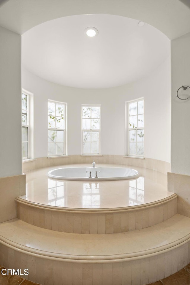 full bath with recessed lighting and a bath