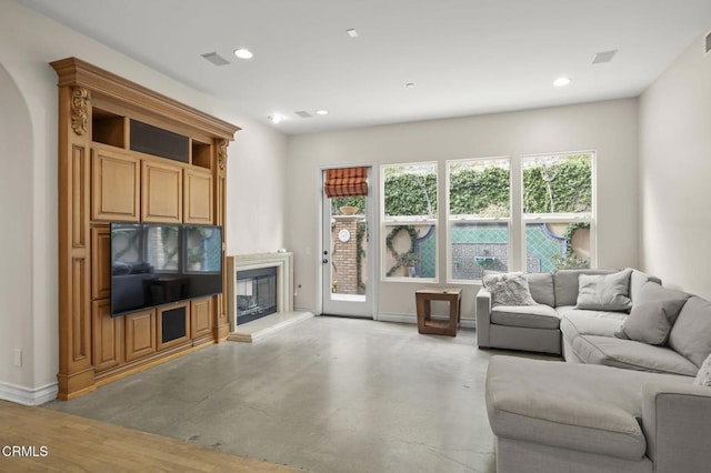 living room with a fireplace, baseboards, visible vents, and recessed lighting