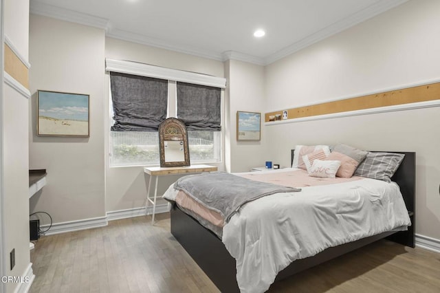 bedroom with crown molding, wood finished floors, baseboards, and recessed lighting