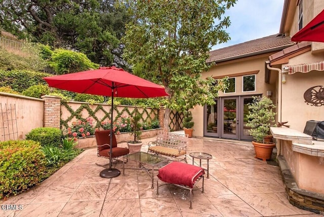 view of patio / terrace with french doors and fence