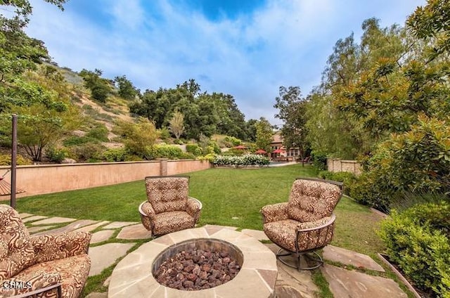 view of yard featuring a patio and a fire pit
