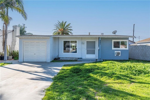 ranch-style home featuring fence, driveway, an attached garage, stucco siding, and a front lawn