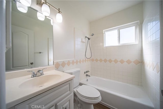 full bathroom featuring bathing tub / shower combination, toilet, and vanity