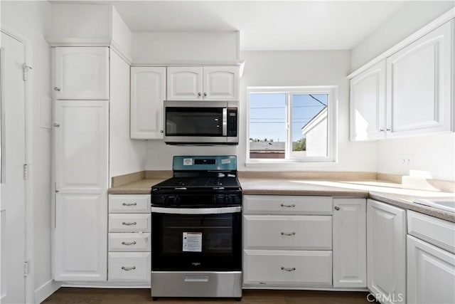 kitchen featuring white cabinetry, light countertops, and appliances with stainless steel finishes