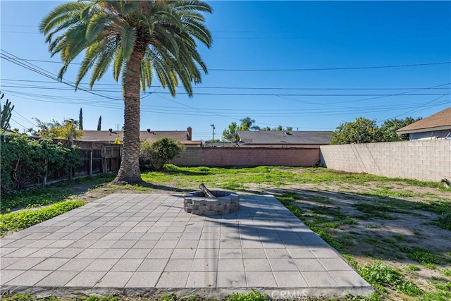 view of patio / terrace featuring a fenced backyard and an outdoor fire pit