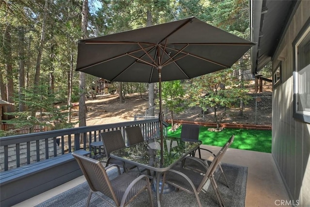 wooden terrace featuring outdoor dining area