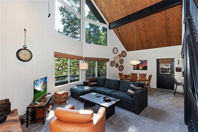 living area with beam ceiling, high vaulted ceiling, and wood ceiling