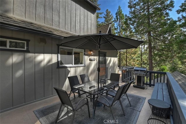 view of patio with outdoor dining area and grilling area