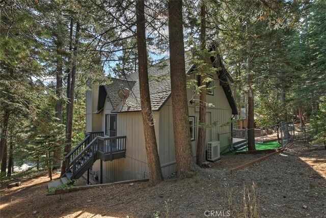view of home's exterior featuring ac unit and fence
