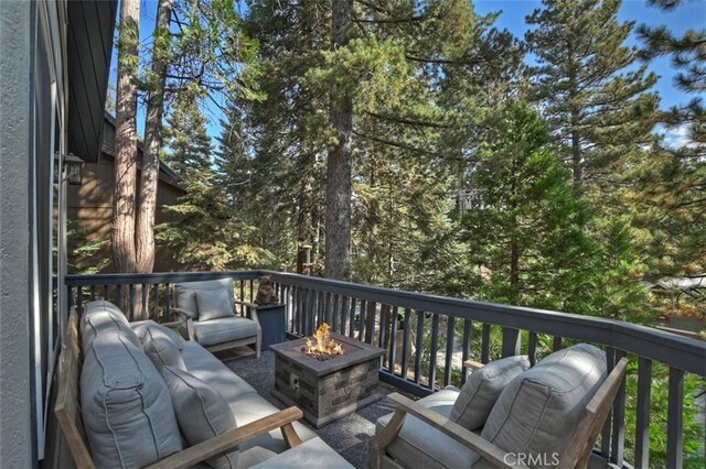 wooden terrace with an outdoor fire pit