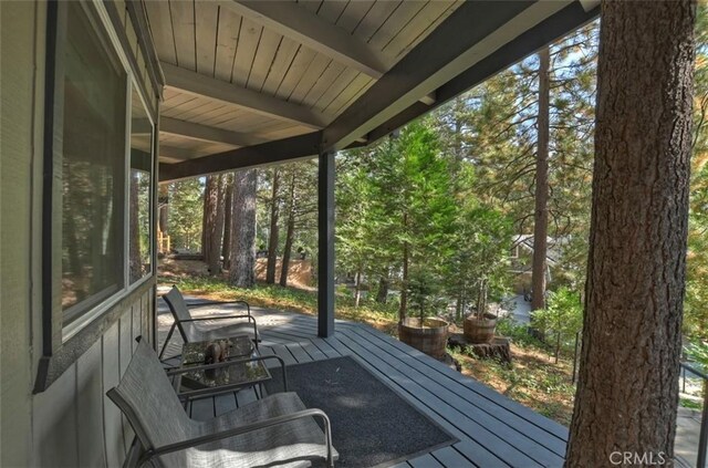 unfurnished sunroom with beam ceiling