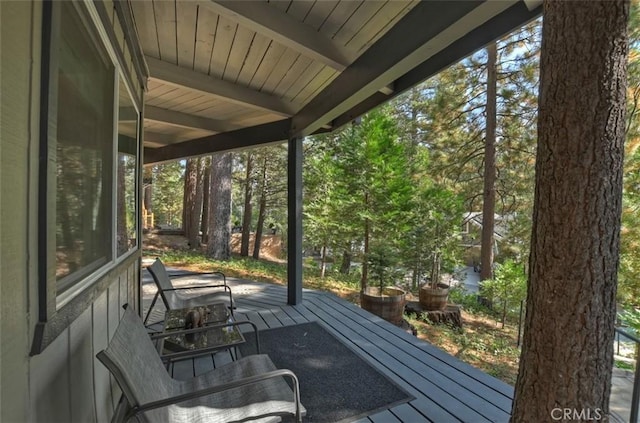 unfurnished sunroom with beamed ceiling