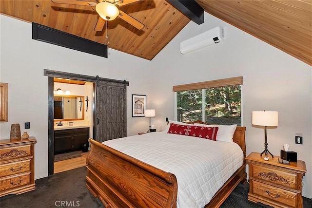 bedroom featuring beam ceiling, a wall mounted air conditioner, a barn door, wooden ceiling, and connected bathroom