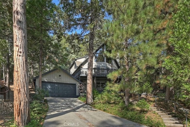 view of front of home with an outdoor structure, stairway, and a garage