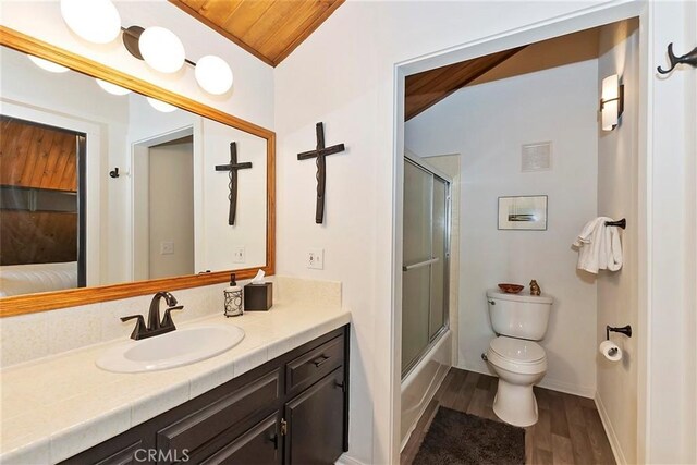 full bath with vanity, wood finished floors, visible vents, enclosed tub / shower combo, and toilet