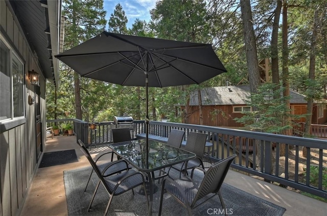 wooden terrace featuring outdoor dining area