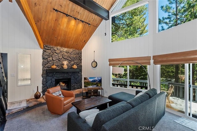 carpeted living area featuring a wealth of natural light, high vaulted ceiling, a fireplace, and wood ceiling