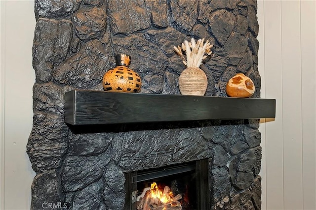 details with a lit fireplace