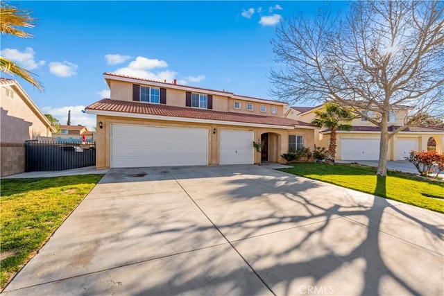 view of front of home featuring fence, a tile roof, concrete driveway, stucco siding, and an attached garage