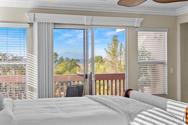 bedroom featuring multiple windows, ornamental molding, a ceiling fan, and access to outside